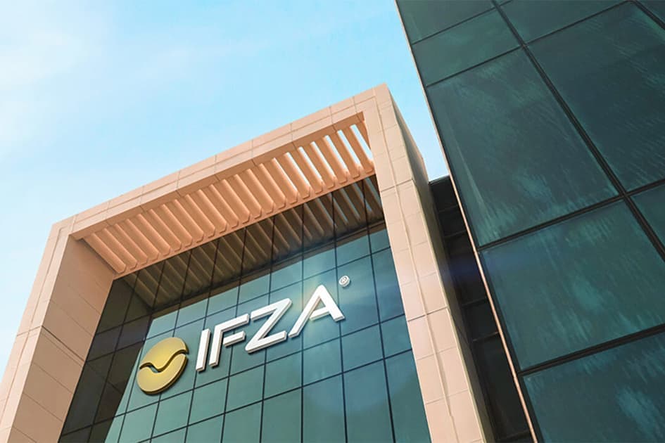 The IFZA free zone headquarters building in Dubai, with the IFZA logo displayed on its glass facade