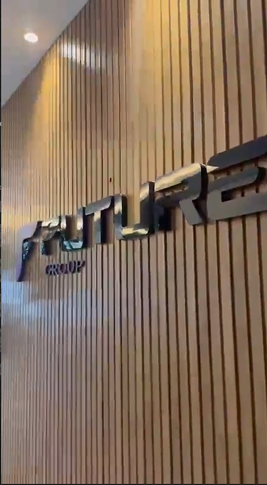 Brushed metal Future Group lettering mounted on a fluted timber wall in the office entrance