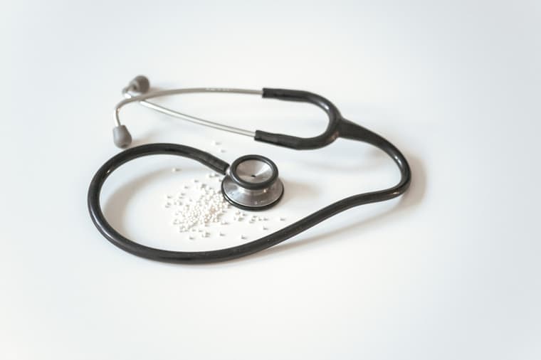 A stethoscope resting on a plain white surface